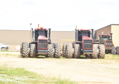 Photo of a trio of large red tractors