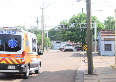 Photo of Indianola railroad crossing with ambulance in foreground